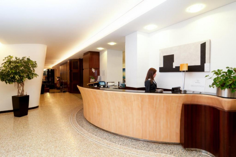 The reception area is step-free, large and well lit. There is a curved reception desk.