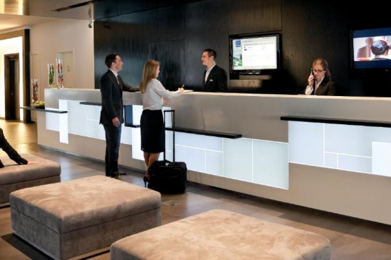The spacious lobby has two seating areas. One has 2 sofas and 2 large pot plants near the elevators. The other has large,low plush banquettes opposite the modern reception desk,which has a small dropped counter area for wheelchair users.