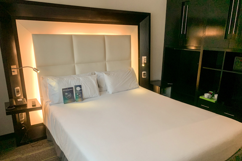 The superior queen room has a queen-sized bed with wooden headboard surround featuring in-built nightstands. There are tea/coffee-making facilities and a safe on the built-in shelving unit.