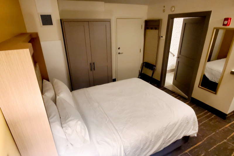 The king guest room has a king-sized bed, a freestanding closet, full-length wall mirror and step-free access to the ensuite restroom.