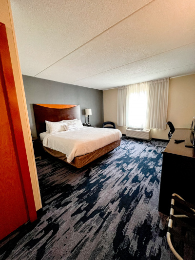 The king guest room has a king-sized bed, nightstands, an armchair, and a desk.