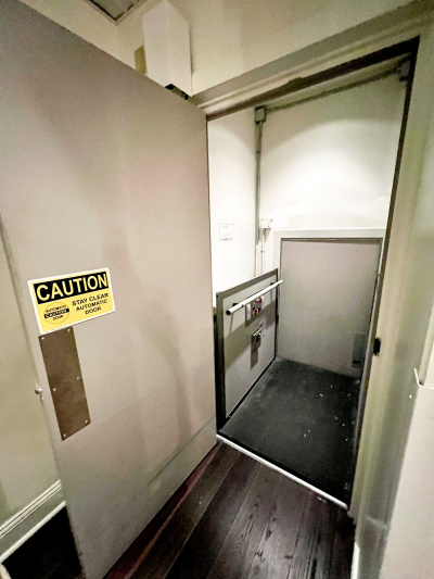 The elevator is fitted with grab rails and has accessible controls.