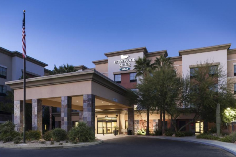 The hotel has a covered entrance with a drop-off area at the door.