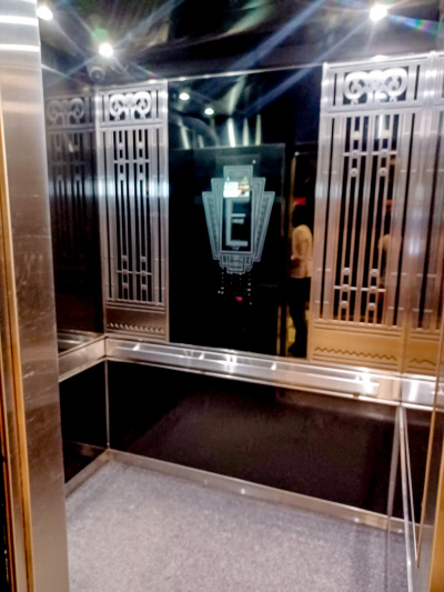 The spacious elevator is fitted with grab bars and has mirrored walls.