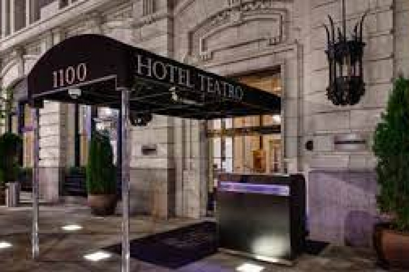Entrance to hotel with elegant stone façade and canopy.