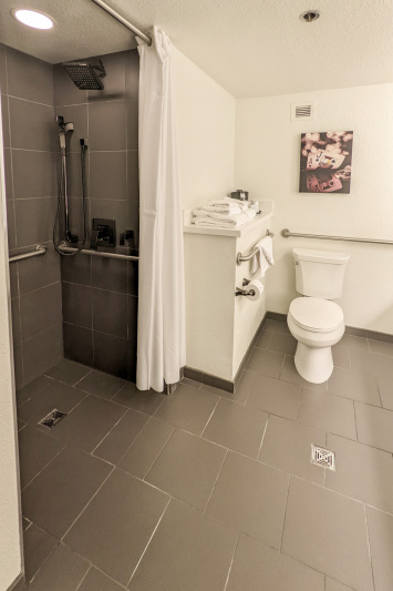 The spacious ensuite restroom is fitted with grab bars and has a roll-in shower.