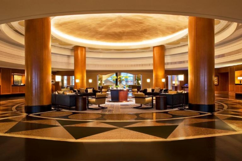 The spacious and elegant circular lobby has four pillars supporting a central dome. Beneath the dome is a sumptuous seating area with sofas and armchairs.