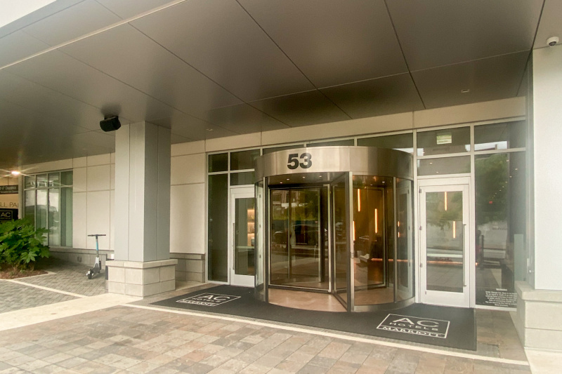 The hotel entrance has a revolving door, with a separate accessible step-free entrance door on either side.