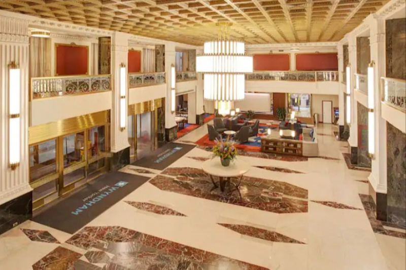 The hotel lobby has a feature chandelier and art deco wall lighting.
