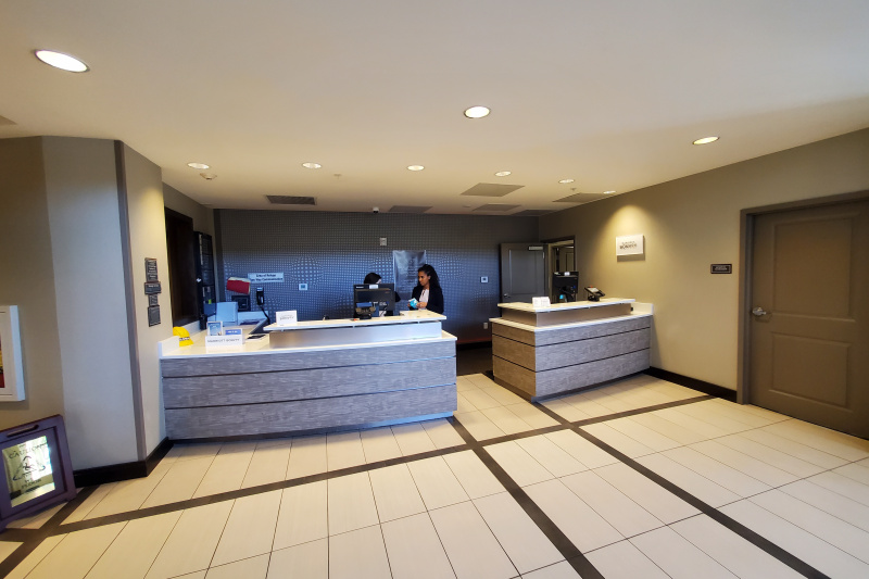 The reception area has a smooth floor and two-tier check-in desk.
