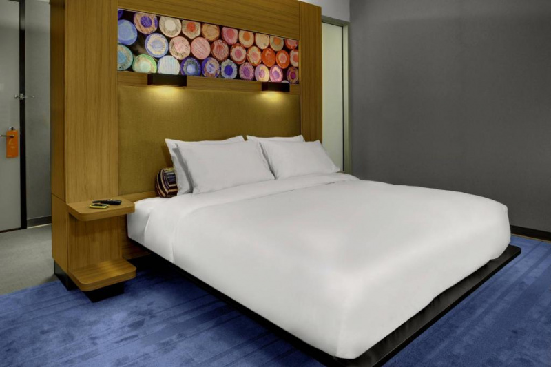 The king bed guest room has a king-sized bed with integral nightstands and artwork on the wall.