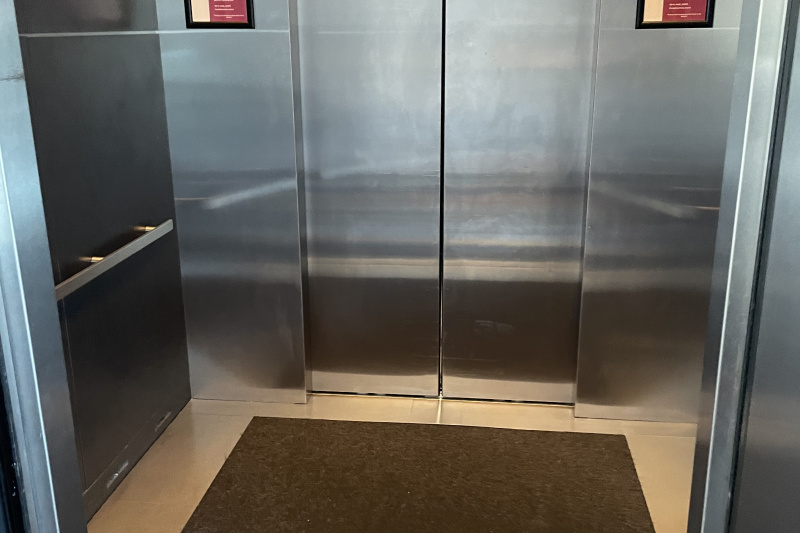 The spacious elevator is fitted with a handrail.