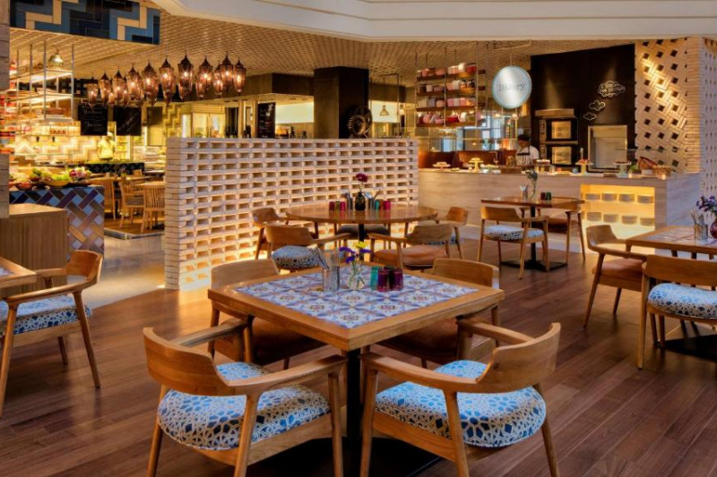 The spacious casual dining area has high food counters and well-spaced tables with moveable chairs.