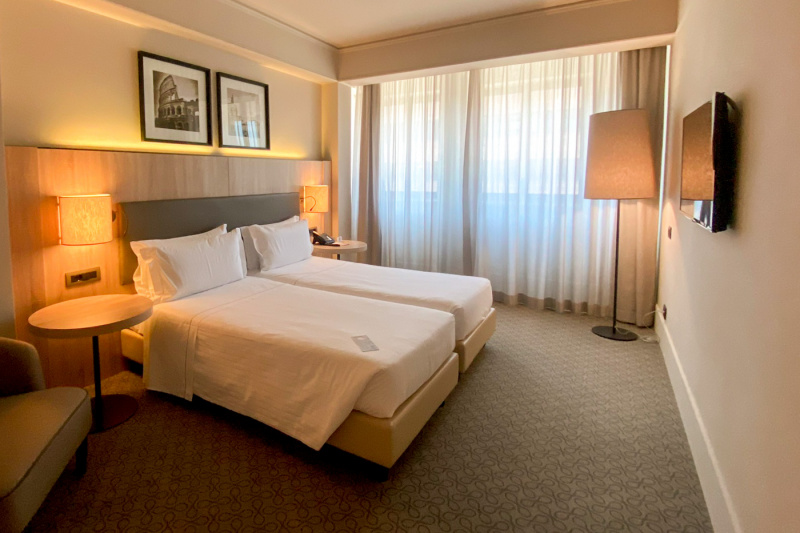 The Family suite has twin beds with reading lights, side tables, a telephone and framed antique photographs,