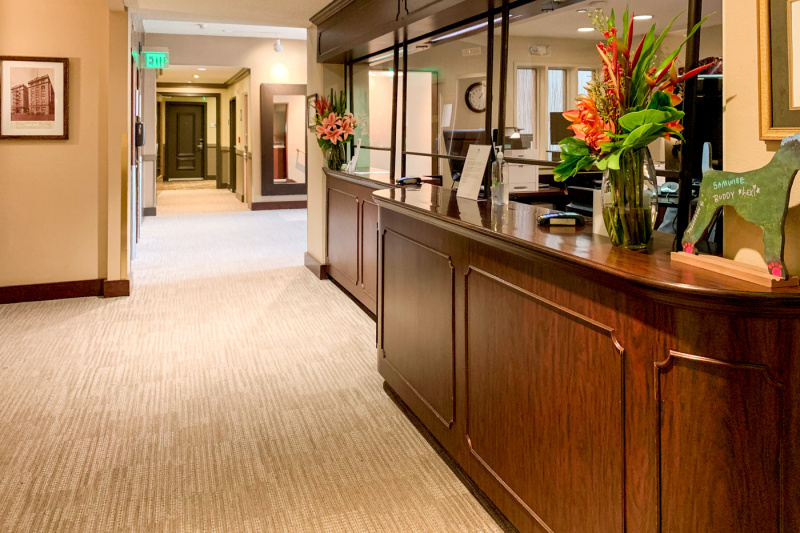 The well-lit spacious reception area has a high counter.