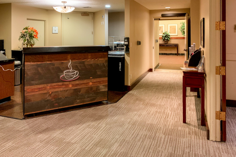 The corridor has a coffee bar to one side with a high counter.