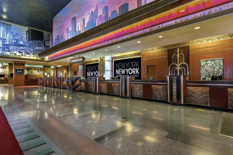 The large lobby is well-lit and has a standard height reception desk.