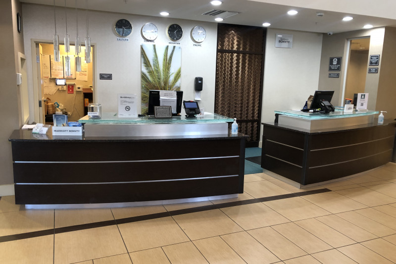 The spacious reception area has a low counter section. The area is well-lit and there are 2 payment machines.