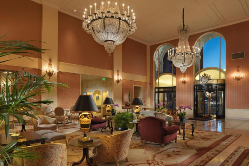 The lobby is spacious with several sets of heavy armchairs, sofas and tables.