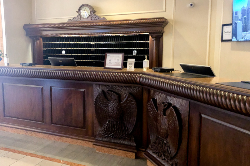 The high, wooden reception desk is accessible.