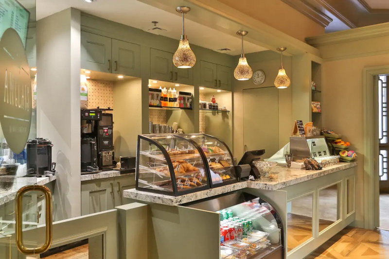 The cafe has a standard height counter with pastries, a drinks cabinet, and an ice cream counter.