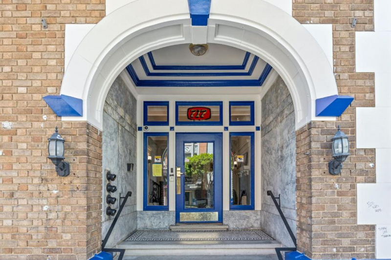 The huge entrance to the hotel is from the sidewalk. There are 3 large, covered doorways, with steps leading up to them. There is a ramp to one side of the stairs.