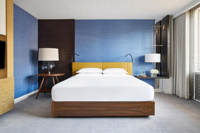 The spacious 1 King room has a king-sized bed with nightstands. There are reading lamps attached to the headboards.