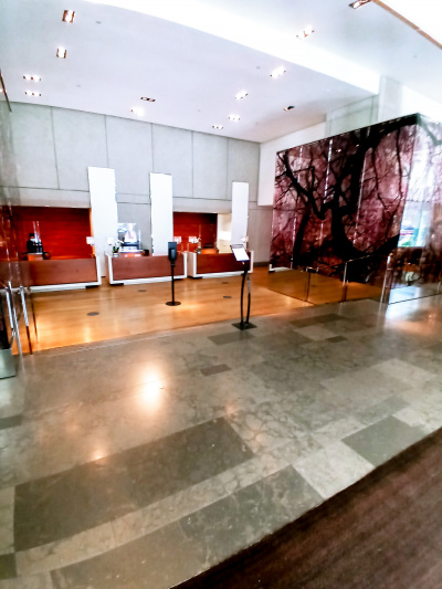 The lobby is spacious and step-free. There are low counter reception desks at one end of the room.