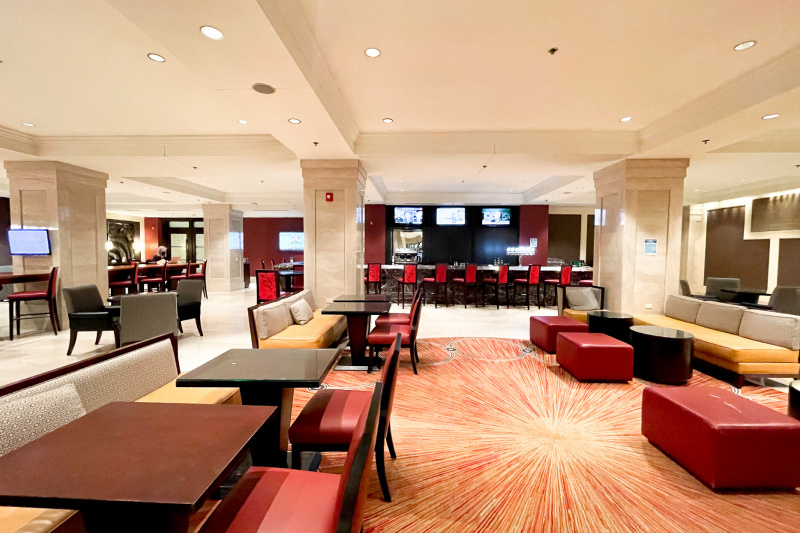 The spacious seating area has padded benches, sofas and low tables. To the far end there is a bar area with a high counter and high stools.