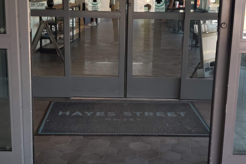 The hotel entrance has two sets of automatic glass sliding doors. There are no steps, but each set of doors has roll-over lips.