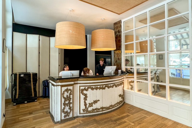 The hotel reception area is uncluttered but has a high countertop.