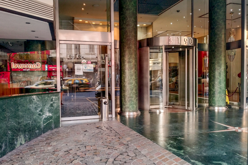 An exterior view of the hotel entrance with revolving doors.