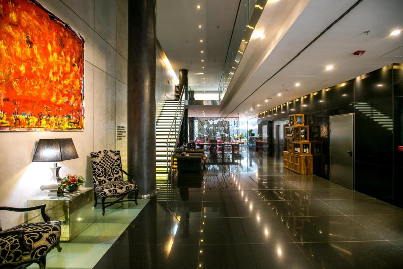 The step-free lobby is spacious with a seating area. There is a staircase going up to another floor.