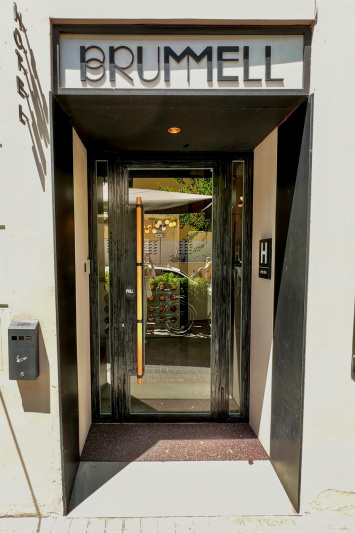 The step-free entrance to the hotel is through a glass door.