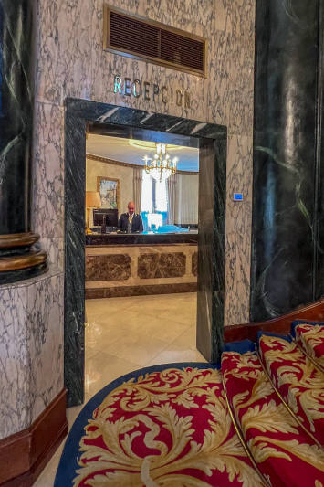 There is a flight of stairs leading to the reception desk which has a high countertop.