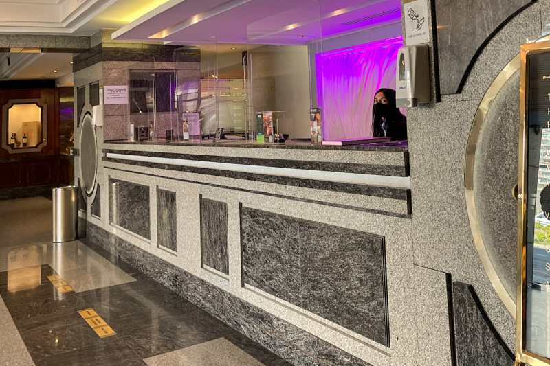 The reception desk has a high countertop.