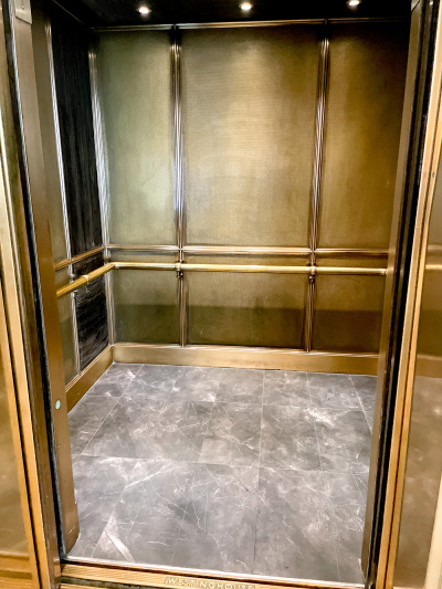 The elevator is step-free and there are handrails around the inside.