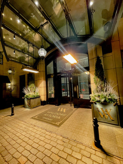 The hotel entrance has step-free access through a revolving glass door flanked by 2 side doors.