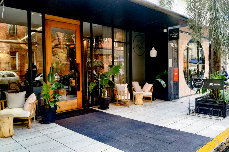 The step-free entrance to the hotel is from the sidewalk. Access is through a large single wooden and glass door.