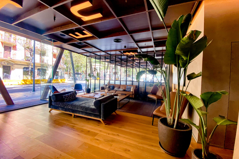 The hotel lobby has a seating area with 2 sofas, 2 armchairs, 2 smaller chairs and a large coffee table.