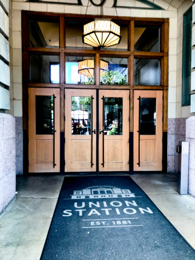 Access to hotel entrance is through a set of tall double doors. There are also 2 single doors on either side of the double doors.