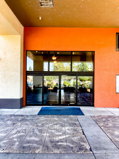 The step-free entrance is through 2 automatic glass sliding doors.