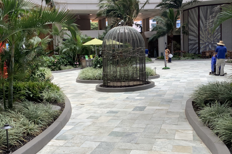 There is a wide paved path leading to the hotel entrance.
