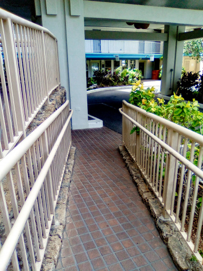 There is a narrow ramp with handrails leading up from the drive-up entrance to the hotel.