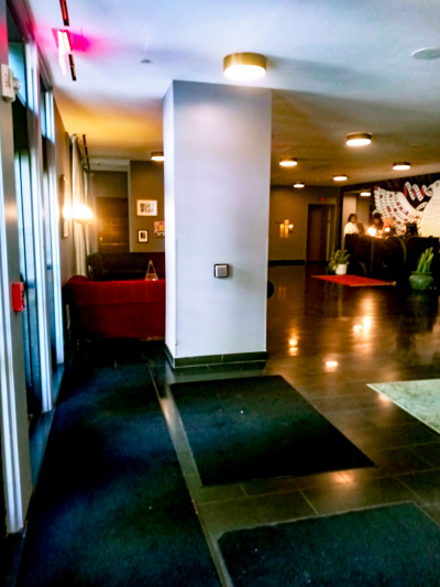 The spacious lobby has 2 sofas and a reception desk. The area is step-free.