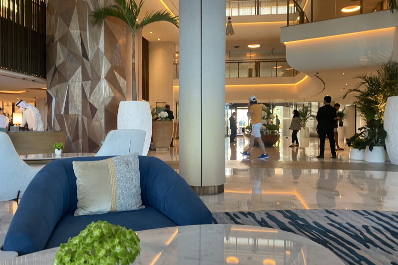 The spacious lobby has low reception desks to the left, assorted tables and movable chairs. There are another 2 floors.