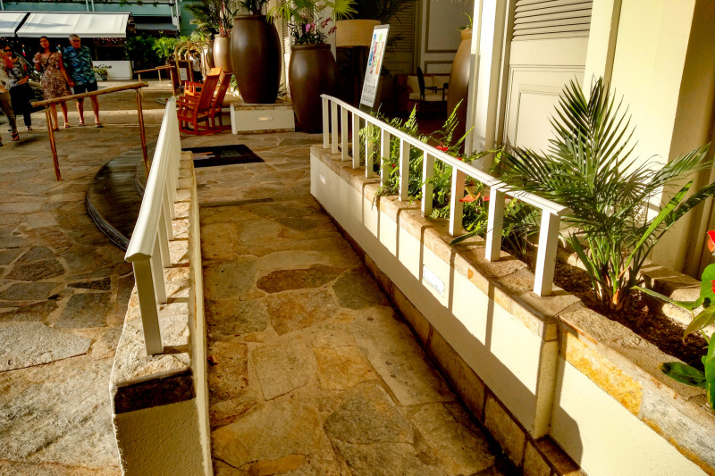 There is a narrow crazy paving ramp with handrails leading to the Veranda entrance.