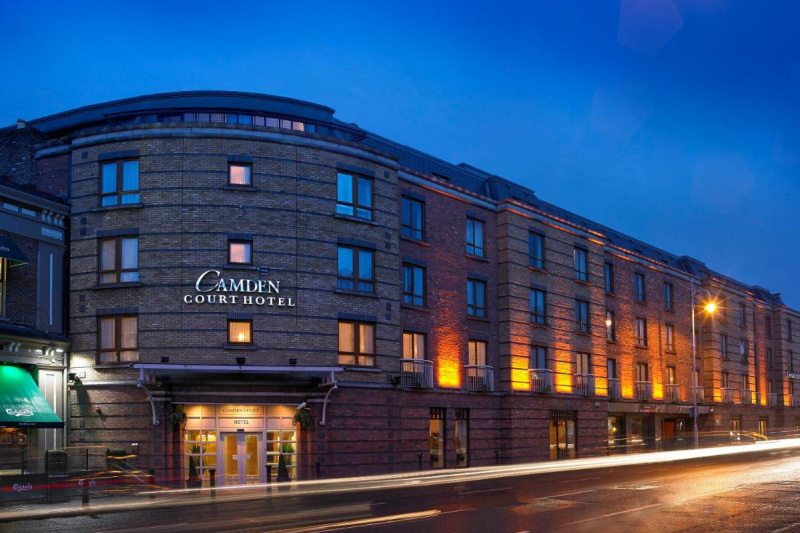 The hotel is a large 3-story building which is accessed from the sidewalk.