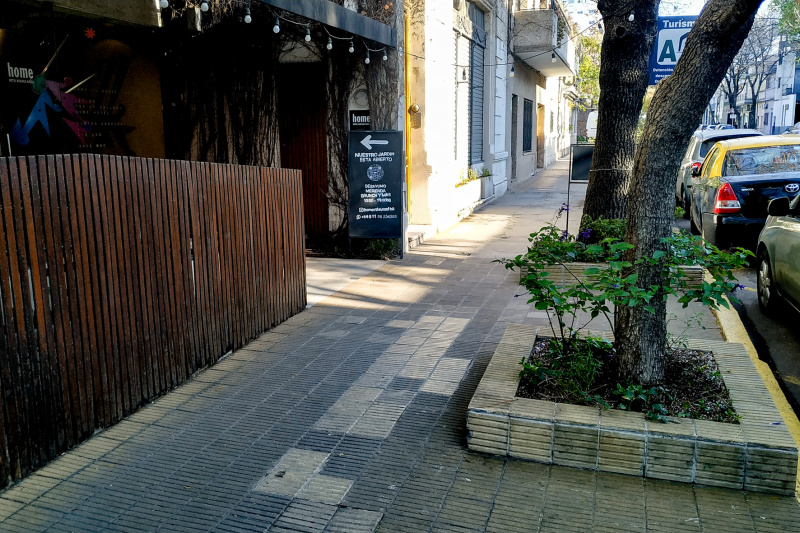 View of the hotel entrance from the sidewalk. There are anti-slip tactile paving stones outside the hotel front. .