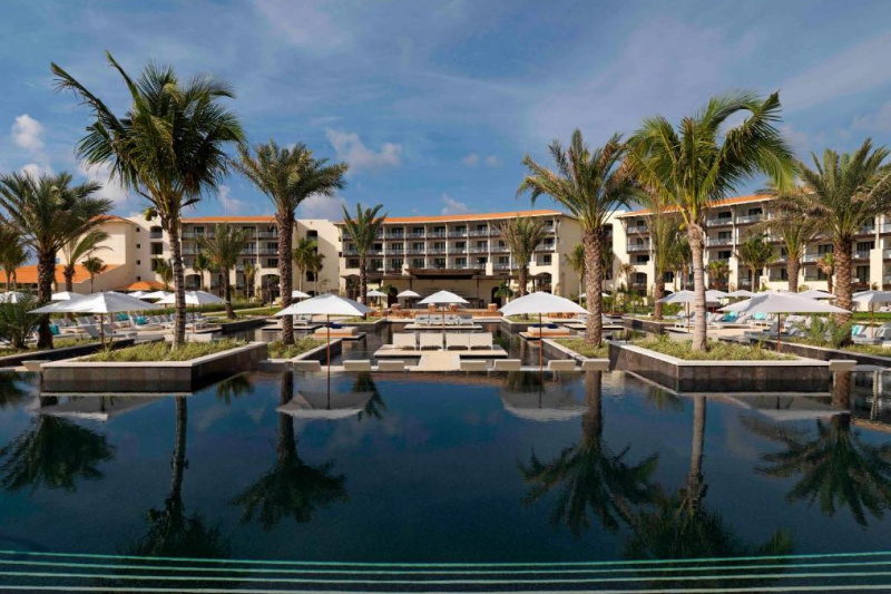 An exterior view of the hotel taken from the pool area. The hotel apartments are around one side of the pool area.